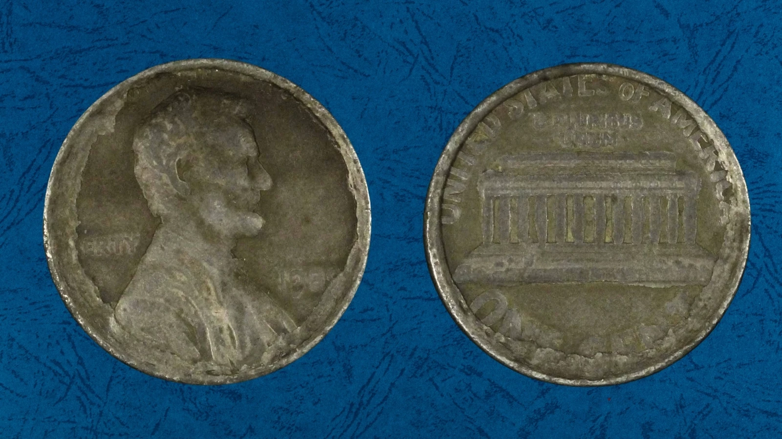 1989 Lincoln cent struck on Roosevelt dime planchet showing smaller silver-colored coin with partial Lincoln design compared to normal penny size